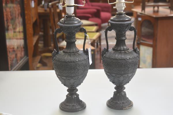 A pair of pottery moulded two handled Classical style urns converted to lamps with Mannerist style