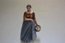 A Royal Doulton china figure, The Farmer's Wife HN3164, decorated with polychrome enamels, with