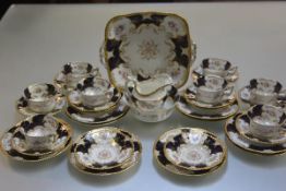 A Coalport china thirty two piece tea service decorated with handpainted floral sprays and blue