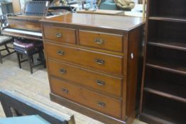 An Edwardian walnut chest, the rectangular top with moulded edge above two short and three graduated