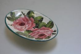 A Wemyss ware oval pin dish with pink cabbage rose pattern design, signed verso Wemyss (30cm x 8cm)