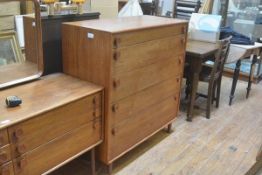 A 1960s Meredew teak tallboy chest fitted five graduated long drawers, raised on turned supports (