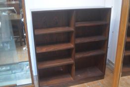 A 1970s rosewood veneered upright two section adjustable shelf bookcase on plinth base (h.119cm x l.