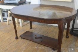 A Whytock & Reid wind out mahogany dining table in the Georgian taste, the moulded top with bowed