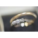 An 18ct yellow gold three stone illusion set diamond ring and a 9ct gold wedding band (2) 1.74 grams