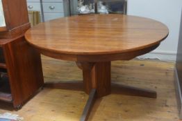 A 1970's Scandinavian circular telescopic dining table on square block column with upswept supports.