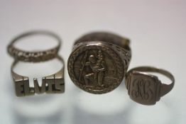 A yellow metal engraved signet ring with pierced shank, a yellow metal St. Christopher style ring, a