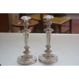 A pair of 19thc Sheffield plated candlesticks with C scroll and acanthus leaf chased decoration to