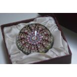 A Perthshire paperweight with millefiori canework decoration, with original box. 6.5cm diameter
