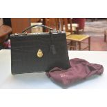 A Mulberry briefcase in embossed crocodile effect black leather, with loop handle to top and brass