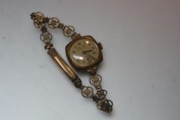 A lady's 9ct gold presentation watch, presented to Ms. Annie Archibald by fellow employees of A.J.