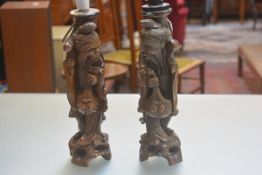 A pair of Japanese carved wood figures of Lohans, raised on carved moulded bases, converted to