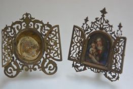 Two engraved and pierced brass devotional frames, late 19th century, each fitted with a pair of