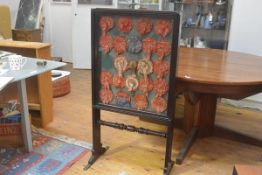 A 19th century glazed double sided firescreen, possibly rosewood, with sliding panels enclosing a