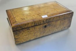 A 19thc maple box desk, the rectangular hinged top with ebony and boxwood strung border enclosing