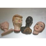 A collection of four various mid 20thc plaster moulded and decorated masks (tallest: 28cm)