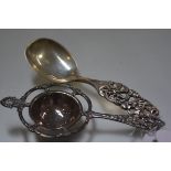 An Norwegian white metal Rococo style tea strainer, 830 standard and Elvesater 925 sterling silver