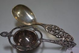 An Norwegian white metal Rococo style tea strainer, 830 standard and Elvesater 925 sterling silver