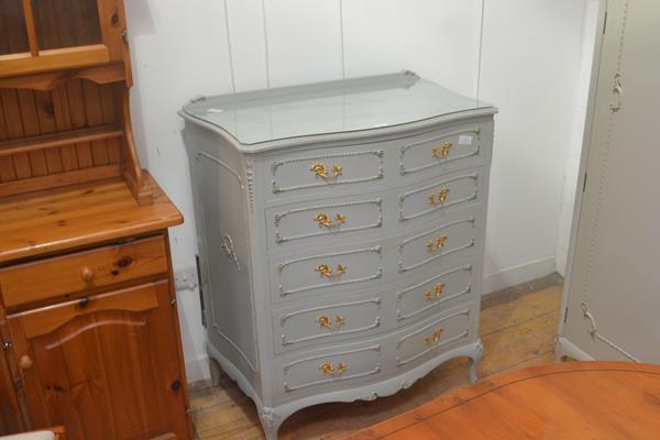 A vintage French green painted and gilt serpentine ledge back chest of drawers, with five long