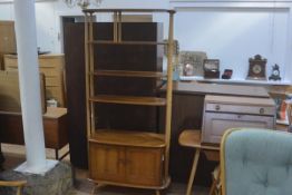 An Ercol light elm room divider with two adjustable shelves and one fixed top shelf above a pair