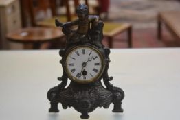 A 19thc cast iron gilded French style mantle clock with figure surmount and enamelled dial, raised