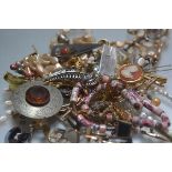 A large collection of costume jewellery inc. white metal, paste earrings, dress rings, brooches, tie