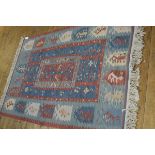 A kelim rug, the centre panel with stylised allover leaf design enclosed within a stylised border,
