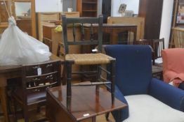 An Edwardian ebonised and ash spindle back child's chair with rush seat. 67cm by 36cm