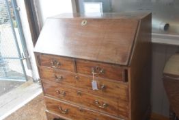 A George III mahogany bureau, the plain top above a fall front enclosing a fitted interior above two