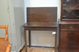 A George III mahogany foldover tea table, with rectangular top, on plain square tapering supports (