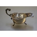 A Chester silver George III style sauceboat with scalloped border and C scroll handle to side,