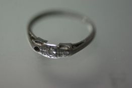 A platinum and diamond two stone ring (one stone lacking), size J. 1.37 grams