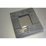 A modern Arts & Crafts style pewter embossed rectangular mirror by David S Brown, paper label