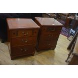 A pair of Eastern hardwood bedside/ lamp tables, the square tops with moulded edge above an