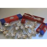 A collection of miscellaneous community plate including table spoons, serving spoons, pickle fork,