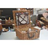 An Optima wicker picnic basket for two with leather fastening straps, complete with knife, fork,