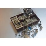 A leather jewellery case containing miscellaneous white metal and silver pendants, dress rings,