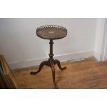 An inlaid mahogany tripod table with brass gallery on associated base. 56cm by 33cm