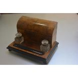A Victorian burr walnut and ebonised desk stationery rack inkstand complete with arched top