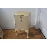 A 1930's/40's bleached walnut bedside cabinet, with single drawer over a fall front, on carved