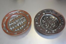 Studio Pottery: two large charger dishes with iron and copper glaze with overglazed stylised leaf