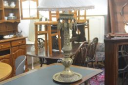 An Eastern brass pierced cast sectional column candlestick converted to table lamp with pierced