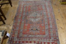 A Caucasian rug, the centre rectangle with centre diamond shaped medallion flanked by a lotus