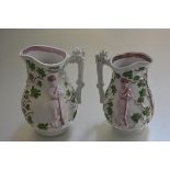 A pair of 19thc moulded lustre jugs decorated with huntsman (h. 21cm and 23cm)