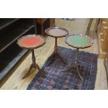 A group of three mahogany scalloped top leather-inset pedestal wine tables, on tripod bases (3).