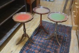 A group of three mahogany scalloped top leather-inset pedestal wine tables, on tripod bases (3).