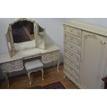 An American cream painted and gilded three piece part bedroom suite comprising a gentleman's style