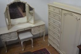 An American cream painted and gilded three piece part bedroom suite comprising a gentleman's style