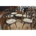 A set of six Ercol dark oak triple splat back dining chairs with shaped wood seats, raised on