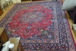 A Tabriz carpet, the centre medallion enclosed within a scalloped scrolling border, with floral